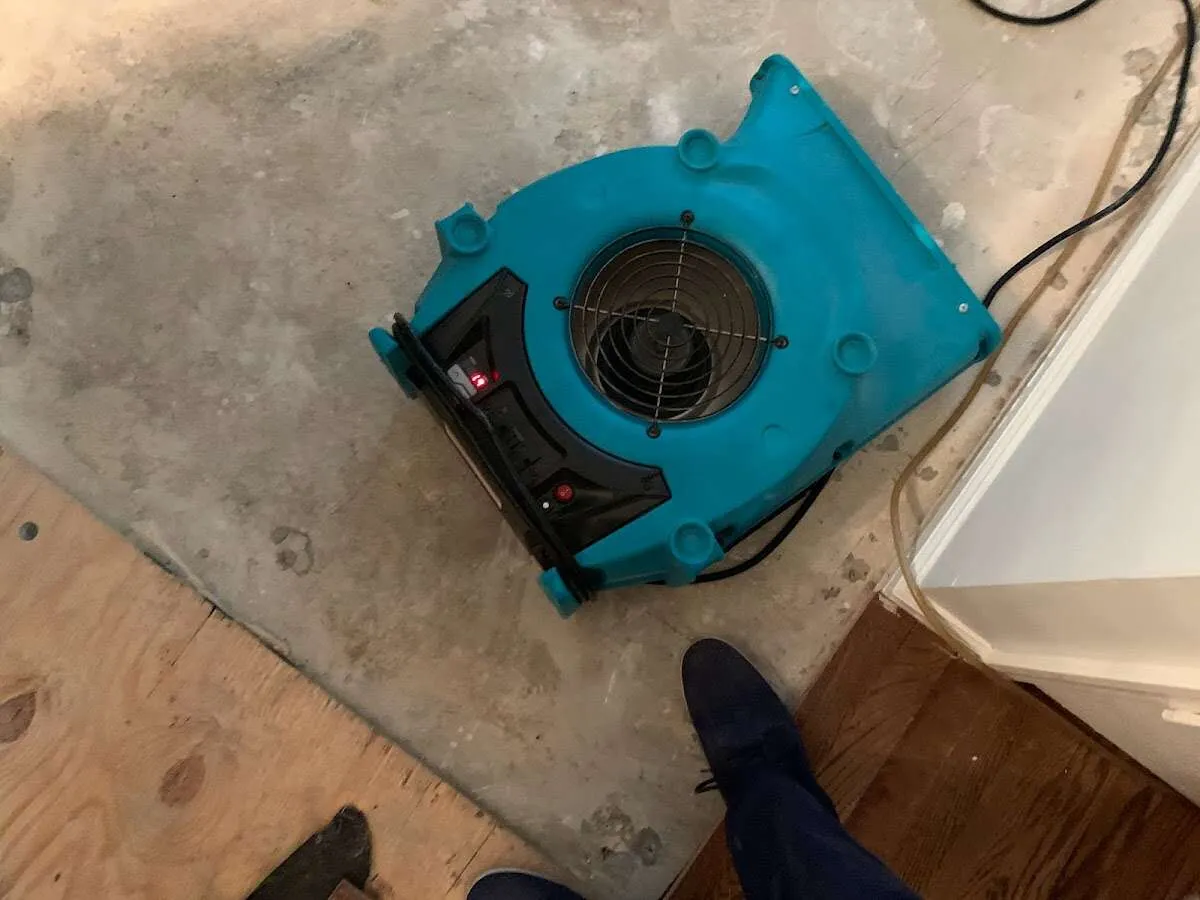 Air mover drying subfloor during Commercial Water Damage Restoration in Camas